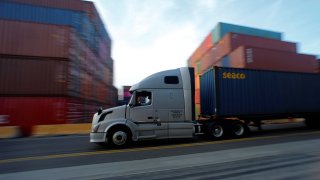 A truck hauls a shipping container at Yusen Terminals (YTI) on Terminal Island at the Port of Los Angeles in Los Angeles, California