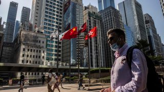 People walk through Exchange Square in Hong Kong on October 28, 2022. Major lenders Standard Chartered and HSBC expressed confidence in the rebound of Hong Kong’s and China’s economy, even as China ramps up its Covid measures and Hong Kong’s economy posted its worst quarter in more than two years.