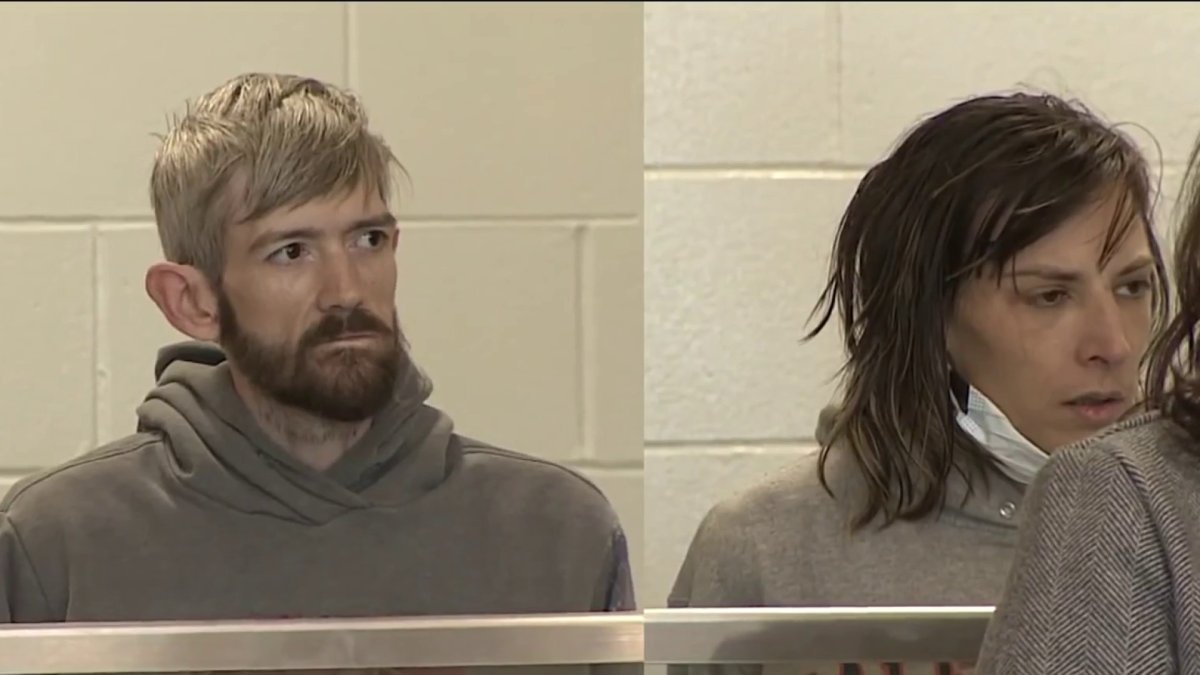 Couple charged after body found in basement freezer, police say