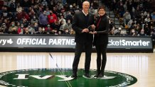 This March 12, 2022, file photo shows Massachusetts Gov. Charlie Baker being presented with an award by Harvard University Director of Athletics Erin McDermott to honor him for the Class of 2022 Legends of Ivy League Basketball during the Ivy League Tournament semifinal between the Pennsylvania Quakers and Yale Bulldogs at Lavietes Pavilion in Boston's Allston neighborhood.