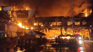 Firefighters and rescue workers gather at the site of a fire at the Grand Diamond City hotel-casino