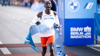 Eliud Kipchoge of Kenya celebrates his marathon world record of 2:01:09 after crossing the finish line at the 2022 BMW Berlin-Marathon on Sept. 25, 2022.