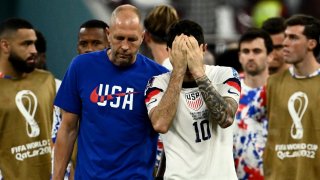 Gregg Berhalter and Christian Pulisic react at the end of the Qatar 2022 World Cup round of 16 football match between the Netherlands and USA at Khalifa International Stadium in Doha on Dec. 3, 2022.