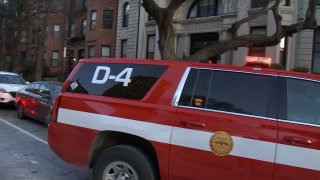 ​Boston firefighters at the scene of a water main break that prompted a building evacuation on Beacon Street at Massachusetts Avenue in Boston on Monday, Dec. 26, 2022.