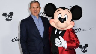 Bob Iger poses with Mickey Mouse attends Mickey’s 90th Spectacular at The Shrine Auditorium on October 6, 2018 in Los Angeles.
