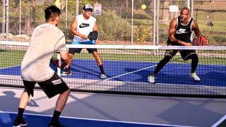 South Pasadena, CA – July 23: Pete Dinero, right, eyes a shot as his partner David Valera looks on as they play pickleball at the Arroyo Seco Racquet Club in South Pasadena on Saturday, July 23, 2022.