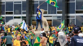 Supporters of Brazilian former President Jair Bolsonaro invade Planalto Presidential Palace while clashing with security forces in Brasilia on January 8, 2023.