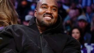 FILE - Kanye West, known as Ye, watches the first half of an NBA basketball game