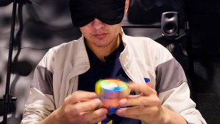 University of Michigan student Stanley Chapel solves a Rubik's Cube while blindfolded
