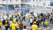 Supporters of Brazilian former President Jair Bolsonaro clash with the police during a demonstration outside the Planalto Palace