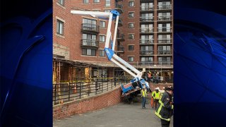 A cherry-picker crane that fell over in Boston's Brighton neighborhood on Thursday, Jan. 12, 2023.