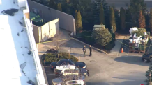 Dumpsters behind police tape at a Swampscott apartment complex on Monday, Jan. 9, 2023.