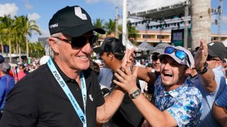 IV Golf CEO Greg Norman, left, walks off the course after the final round of the LIV Golf Team Championship at Trump National Doral Golf Club, Sunday, Oct. 30, 2022, in Doral, Fla.