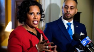 Tanisha Sullivan, President of NAACP Boston, left, addresses reporters outside Massachusetts Gov. Maura Healey's at the Statehouse, Monday, Feb. 27, 2023, in Boston.