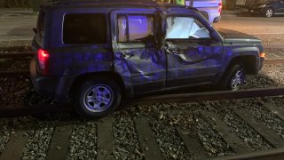 A damaged SUV on Green Line tracks in Brookline, Massachusetts, early on the morning of Feb. 7, 2023.