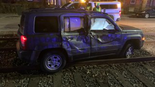 A damaged SUV on Green Line tracks in Brookline, Massachusetts, early on the morning of Feb. 7, 2023.