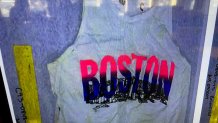 white tank top that says Boston on the front of it