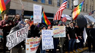 Pro- and anti-drag protestors gather outside of Sidetrack Bookshop in Royal Oak, Michigan, on March 11, 2023.