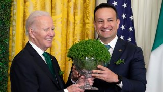 President Joe Biden and Ireland's Taoiseach Leo Varadkar hold a bowl of shamrocks during a St. Patrick's Day reception in the East Room of the White House, March 17, 2023, in Washington.