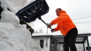 Ashby, MA – January 21: A man shovels snow in a driveway on Fitchburg State Road. (Photo by John Tlumacki/The Boston Globe via Getty Images)