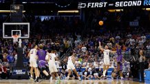 JP Pegues #1 of the Furman Paladins shoots the game winning three point basket against the Virginia Cavaliers during the second half in the first round of the NCAA Men's Basketball Tournament at Amway Center on March 16, 2023 in Orlando, Florida.