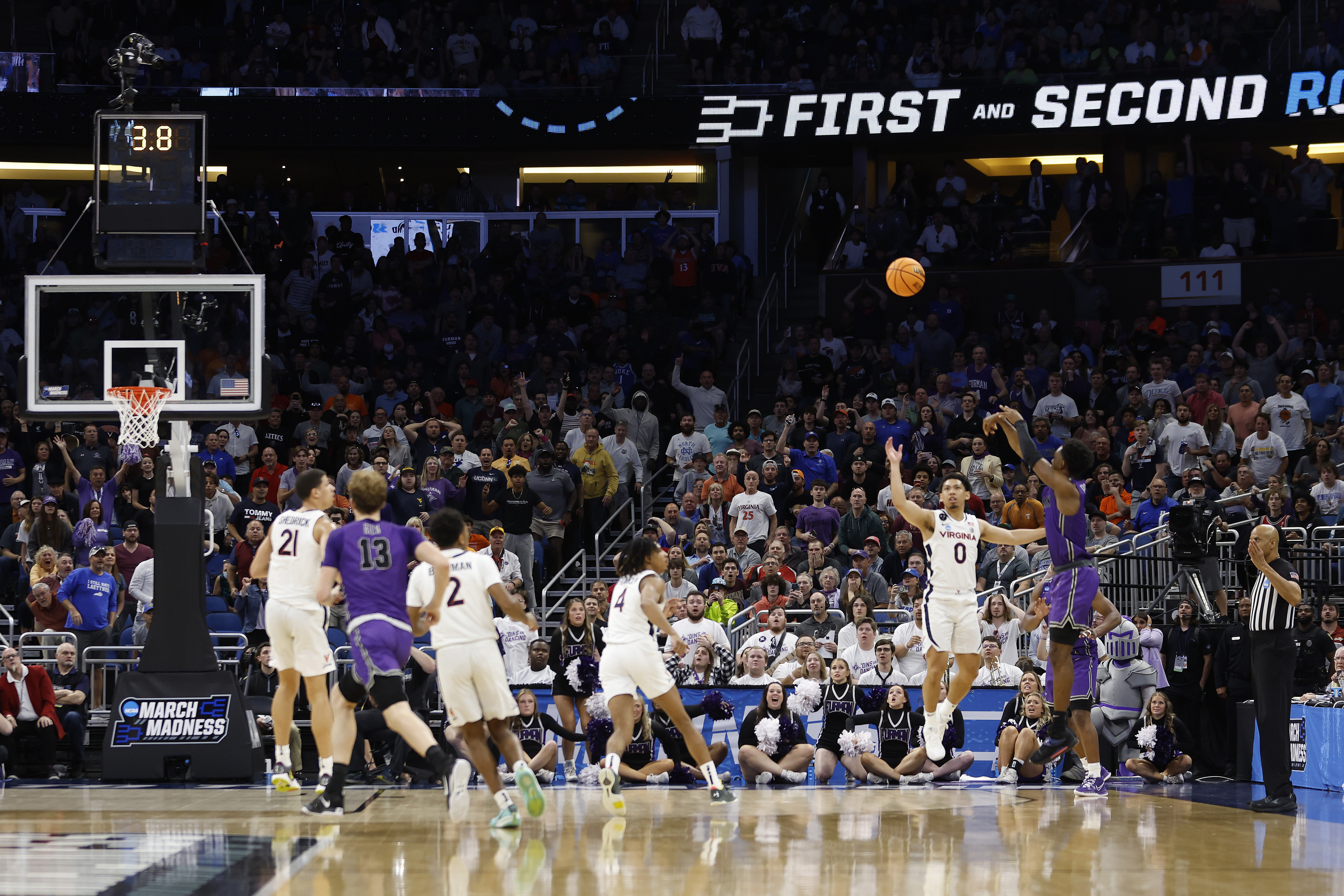 JP Pegues #1 of the Furman Paladins shoots the game winning three point basket against the Virginia Cavaliers during the second half in the first round of the NCAA Men's Basketball Tournament at Amway Center on March 16, 2023 in Orlando, Florida.