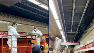 Work being done to remove ceiling tiles at Harvard Station on the MBTA Red Line in Cambridge, Massachusetts.