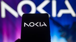 Nokia new logo displayed on mobile, with Nokia logo on screen.