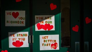 FILE – Messages of support for teacher Abby Zwerner, who was shot by a 6-year-old student, grace the front door of Richneck Elementary School Newport News, Va. on Jan. 9, 2023.