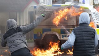 Masked youths throw petrol bombs at a police Land Rover as Republican protesters opposed to the Good Friday Agreement hold a parade in Londonderry, Northern Ireland,Monday, April 10, 2023. President Biden is due to visit Northern Ireland and Ireland to celebrate the 25th Anniversary of the Good Friday Agreement .(AP Photo/Peter Morrison)