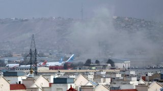 FILE – Smoke rises from a deadly explosion outside the airport in Kabul, Afghanistan, Thursday, Aug. 26, 2021.