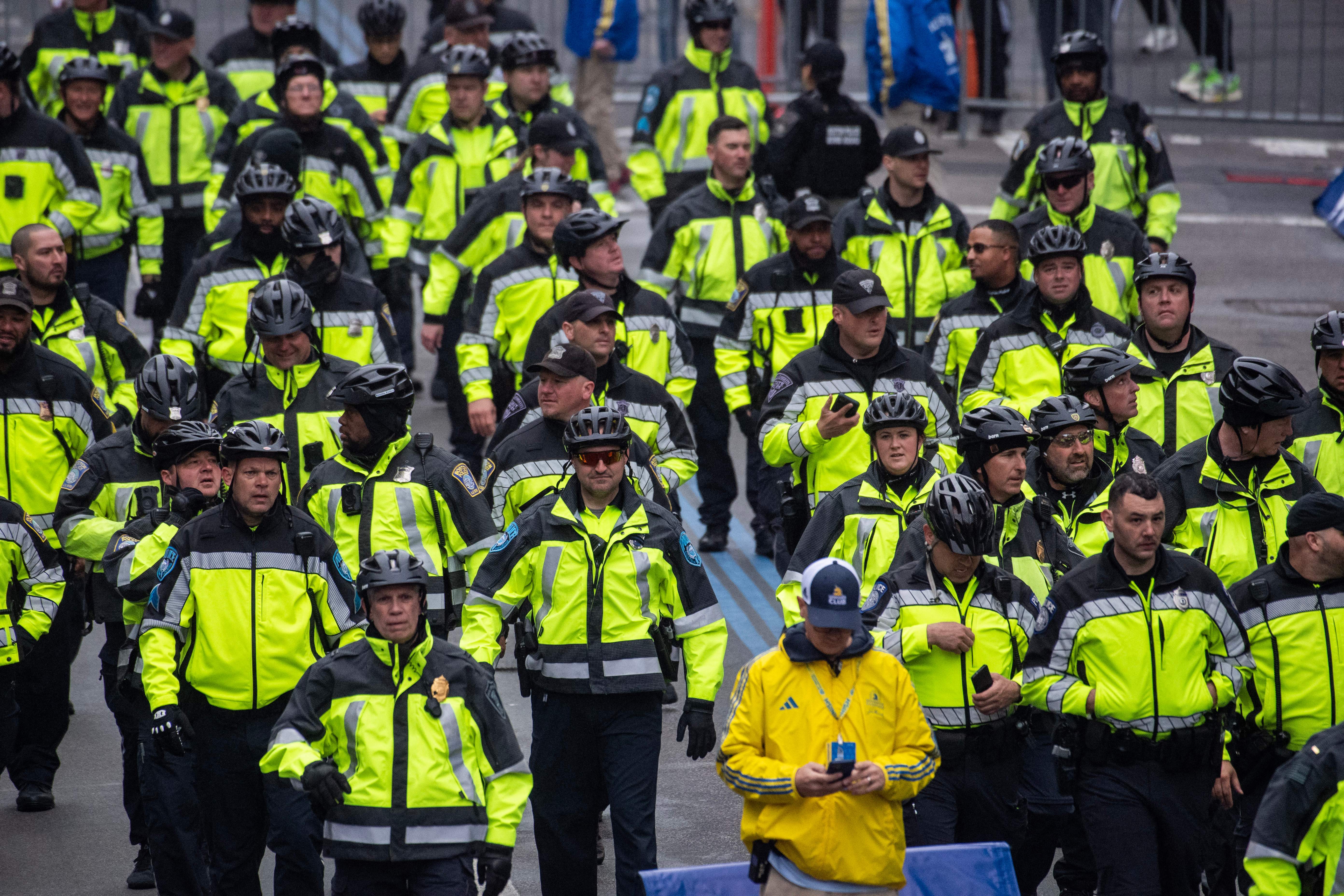 Police officers walk near the finish line during the 127th Boston Marathon in Boston, Massachusetts on April 17, 2023. – 30,239 people are entered to run the 26.2 mile (42.2K) race from a total of 106 countries and all 50 US states.  This year also is the 10 year anniversary of the 2013 bombings. (Photo by Joseph Prezioso / AFP) (Photo by JOSEPH PREZIOSO/AFP via Getty Images)