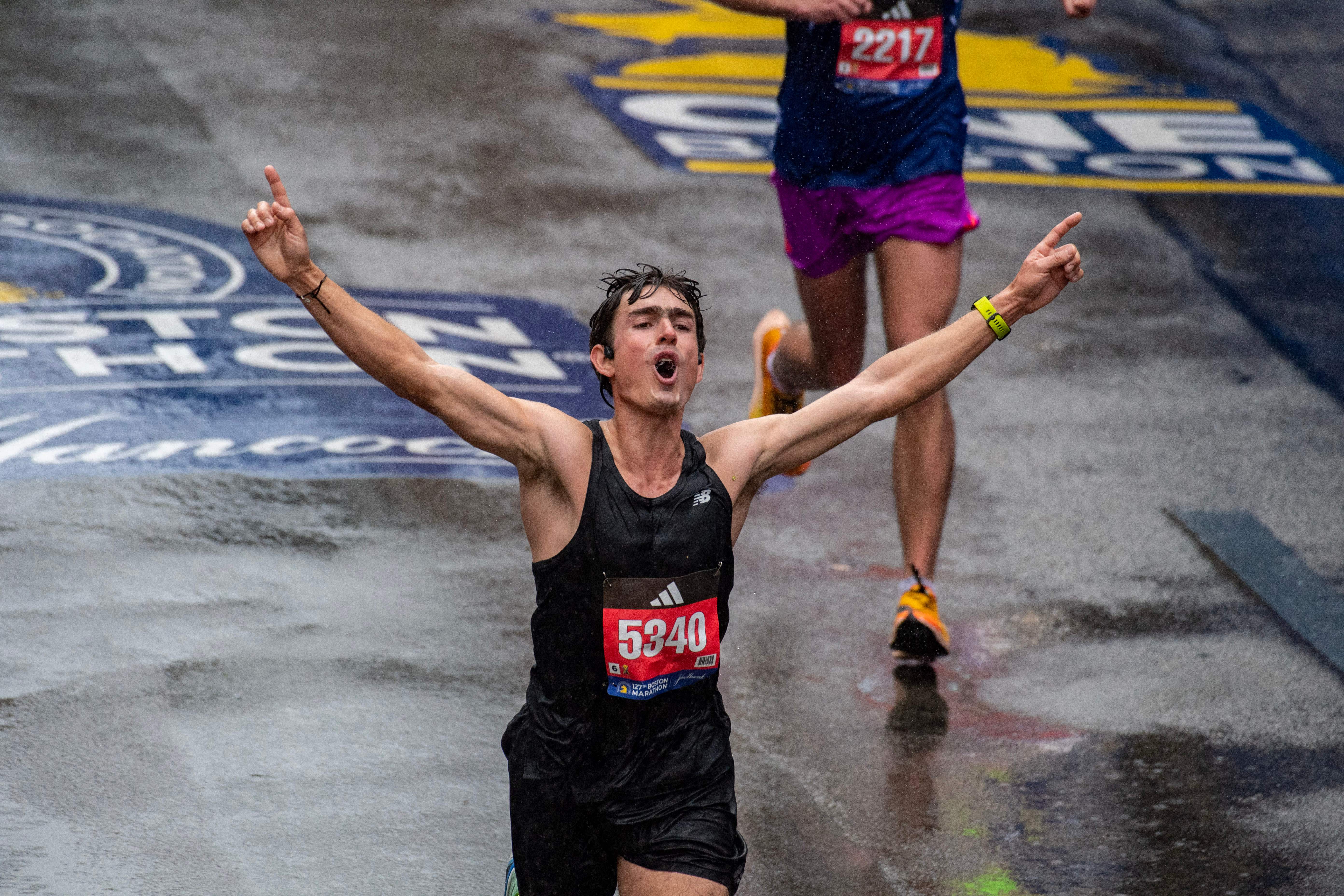 Runners make their way to the finish line during the 127th Boston Marathon in Boston, Massachusetts on April 17, 2023. – In wet and windy conditions, 2022 champion Chebet of Kenya took his time before surging away in the closing stages to become the first man to defend the Boston crown since compatriot Robert Kipkoech Cheruiyot completed a hat trick of victories between 2006-2008. (Photo by Joseph Prezioso / AFP) (Photo by JOSEPH PREZIOSO/AFP via Getty Images)