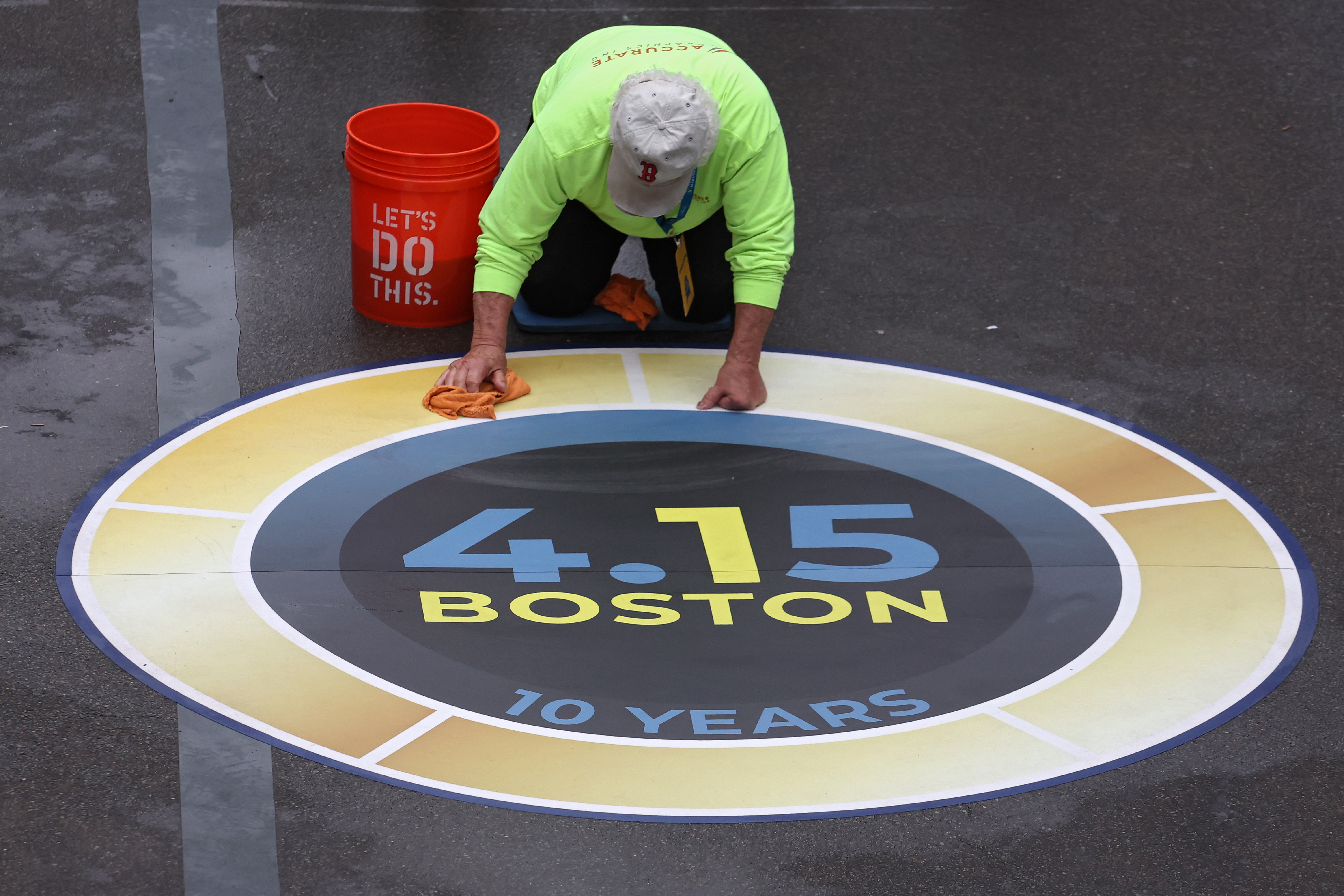 BOSTON, MASSACHUSETTS – APRIL 17: A person cleans a logo near the finish line before the start of the 127th Boston Marathon on April 17, 2023 in Boston, Massachusetts. (Photo by Maddie Meyer/Getty Images)