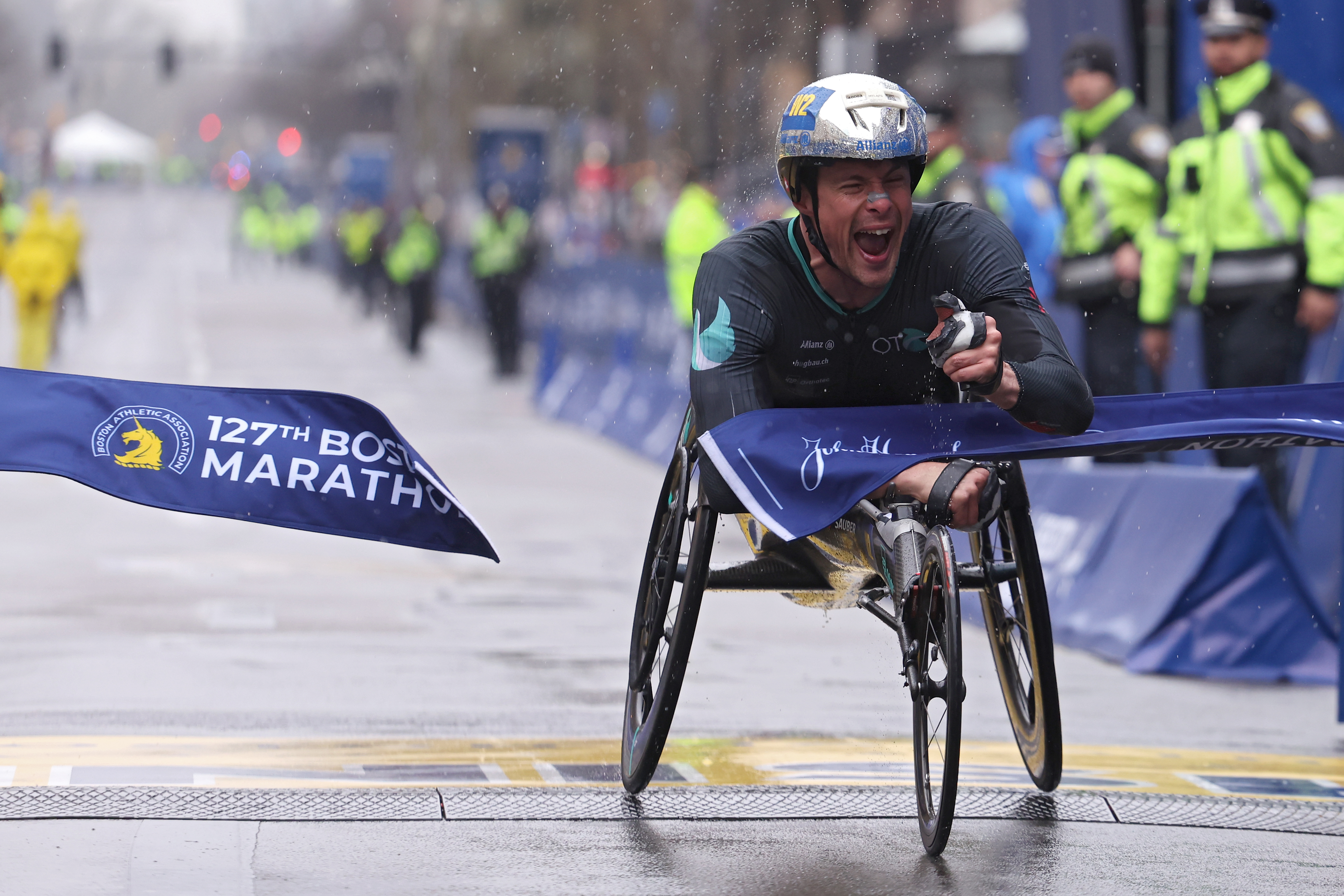 Marcel Hug of Switzerland crosses the finish line and takes first place in the professional Men’s Wheelchair Division during the 127th Boston Marathon on April 17, 2023 in Boston, Massachusetts.