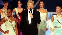 Jerry Springer, the host of Miss World, with some of the entrants, during the Miss World contest at The Millennium Dome in Greenwich.   (Photo by Michael Crabtree - PA Images/PA Images via Getty Images)