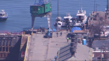 A car being pulled from the water of Boston Harbor on Monday, April 3, 2023.