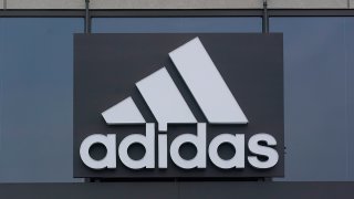 FILE - A sign is displayed in front of an Adidas retail store in Paramus, N.J., Oct. 25, 2022.