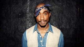 Rapper Tupac Shakur poses for photos backstage after his performance at the Regal Theater in Chicago, Ill., in March 1994.