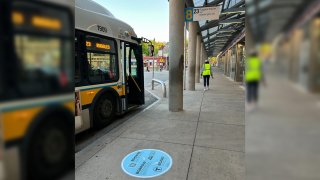 A Boston Public Library QR code decal at a bus stop in the city.