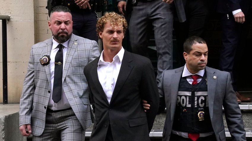 US Marine veteran Daniel Penny (C) is walked out of the New York Police Department 5th Precinct in Lower Manhattan, May 12, 2023 on his way to a arraignment after he surrendered to authorities after being charged with 2nd Degree Manslaughter in the chokehold death of Jordan Neely. The death of Jordan Neely -- widely identified as a Michael Jackson impersonator who often performed on the train -- earlier this month sparked outrage. (Photo by TIMOTHY A. CLARY / AFP) (Photo by TIMOTHY A. CLARY/AFP via Getty Images)