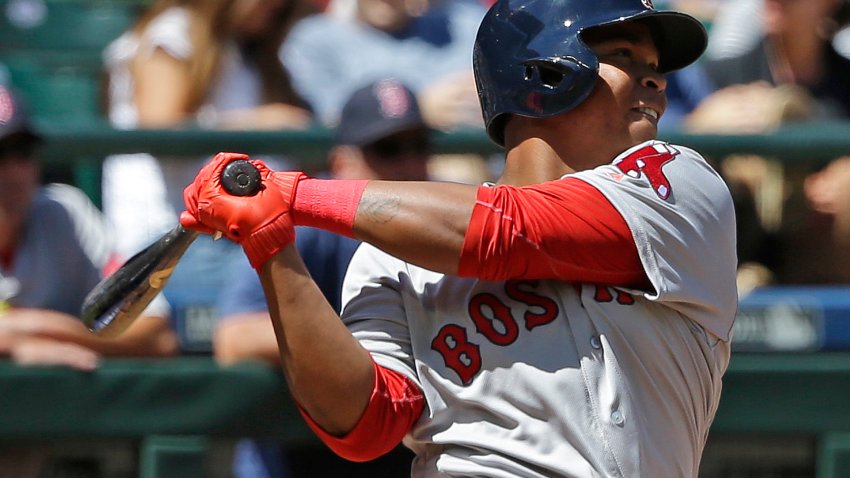 Boston Red Sox’s Rafael Devers follows through after hitting a solo home run, his first major-league hit, in the third inning of a baseball game against the Seattle Mariners, Wednesday, July 26, 2017, in Seattle. (AP Photo/Ted S. Warren)