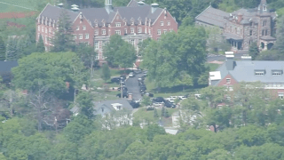 Vehicles outside St. John's Prep in Danvers, Massachusetts, on Monday, May 22, 2023, when an active shooter threat was reported, bringing out a heavy police response.