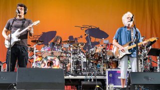 (L-R) John Mayer, Jay Lane and Bob Weir of Dead and Company perform during 2023 New Orleans Jazz & Heritage Festival at Fair Grounds Race Course on May 06, 2023 in New Orleans, Louisiana.