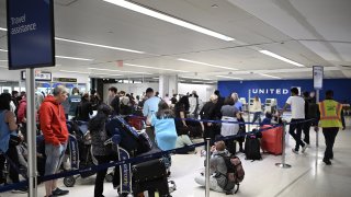 Passengers wait at the Newark Liberty International Airport as more than 2000 flights were canceled due to the nationwide storm in New Jersey, United States on June 27, 2023. 