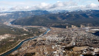 FILE – The town of Libby Mont., is shown Feb. 17, 2010. A major U.S. railroad found partially liable for asbestos contamination that’s killed hundreds of people in a Montana town is trying to convince a federal jury a local clinic submitted hundreds of asbestos claims for people who weren’t sick.