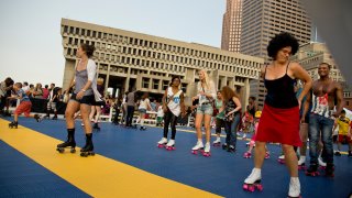 This July 18, 2014, file photo shows hundreds of skaters doing their thing to disco music during the Donna Summer Roller Disco Tribute at City Hall Plaza.