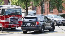 A downed power line across several vehicles near city hall in Chelsea, Massachusetts, on Friday, June 16, 2023.