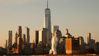 Skyline of lower Manhattan and One World Trade Center in New York City and the Water’s Soul sculpture on July 11, 2023, in Jersey City, New Jersey. (Photo by Gary Hershorn/Getty Images)