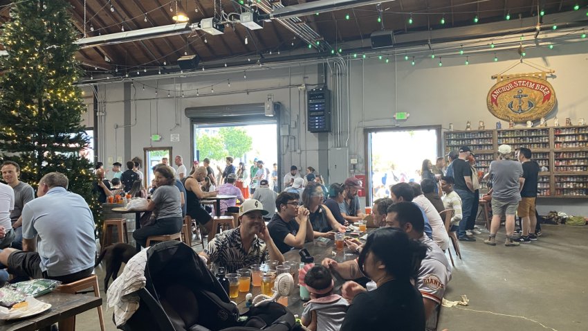 People gather for drinks at San Francisco’s Anchor Brewing Company. July 22, 2023. NBC Bay Area Photo/ Alyssa Goard.